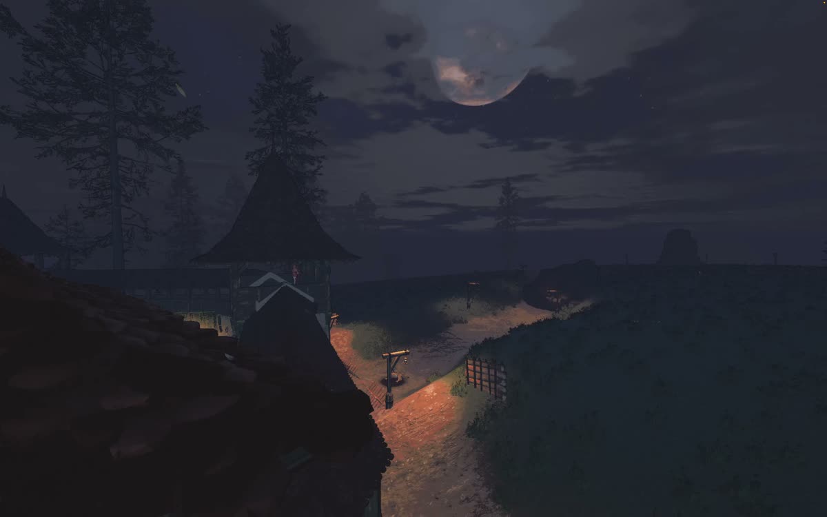 The moon emerging over a distant outpost and winding lantern-lit road.
